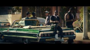 Dom and his fellow gang members sitting on their car.